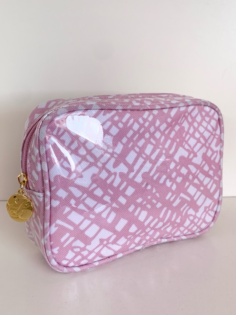 Estée Lauder pink plastic covered zippy pouch